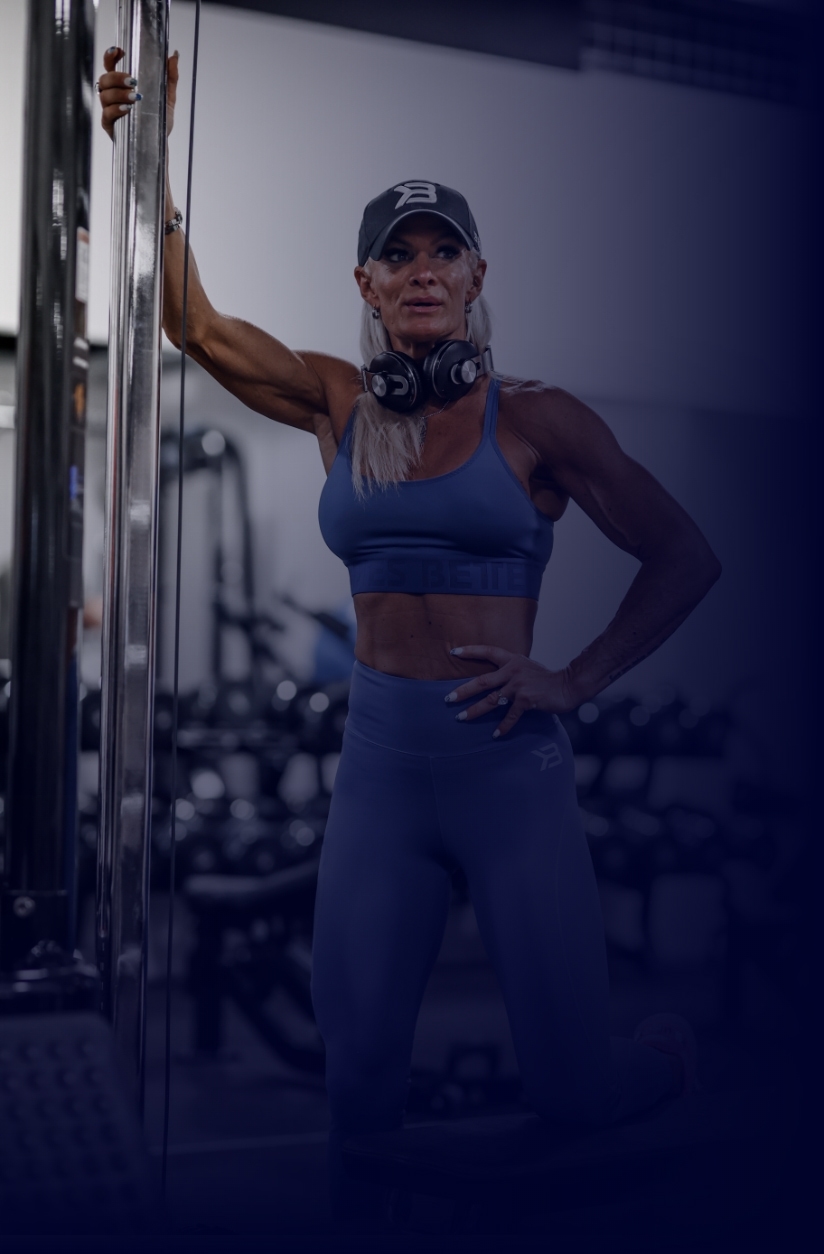 Coach Diva posing in the gym looking away from the camera